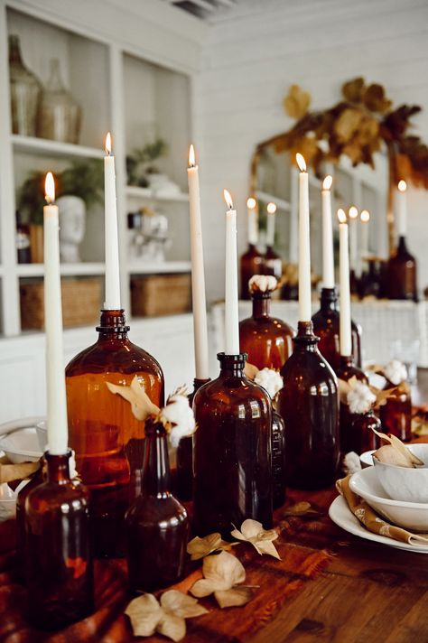 Fall Amber Bottle Centerpiece - Liz Marie Blog Industrial Farmhouse Centerpiece, Amber Fall Decor, Cute Fall Party Ideas, Moody Fall Dinner Party, Cozy Fall Party, Fall Inspiration Decor, Candles In Bottles, New Fall Decorating Ideas, Autumnal Party