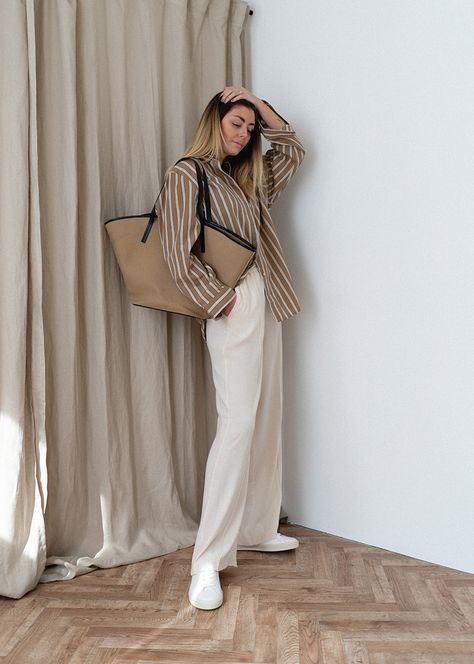 Emma Hill wears brown and white stripe oversized shirt, white wide leg trousers, white trainers, neutral canvas tote bag. Chic causal Spring Summer outfit White And Beige Outfit Summer, Trousers With Shirt Women, Beige And White Striped Shirt Outfit, Brown Striped Button Up Outfit, Causal Trousers Outfit, Beige Oversized T Shirt Outfit, White And Brown Striped Shirt Outfit, Light Brown And White Outfit, Brown Stripes Shirt Outfit