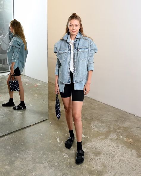 Leave it to the eldest Hadid for a simple yet impactful take on Birkenstocks that's worth recreating. Start with your go-to basic biker shorts, a white tee, and a pair of athletic socks. Then layer a boxy denim jacket over a chambray button-down and, voilà, a supermodel-approved outfit. Hadid’s favorite pair of shoes are from the Valentino x Birkenstock collab Birkenstocks With Socks, Sandals With Socks, 90s Inspired Outfits, Black Biker Shorts, Sock Outfits, Dad Fashion, Fashion Shoes Flats, Sandals Outfit, Double Denim