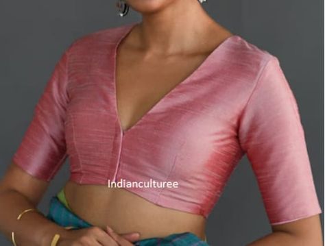 Rose pink solid saree blouse has a V-neck, short sleeves, and a stylized front with front hook and eye closure Fabric:  Pure  Silk Readymade Saree blouse Front open - without pads Princess cut Soft, light-weight and breathable fabric. If you could include following info in the note to whenever you placed the order, you will get best-matched blouse * Chest size: * Waist size: * Blouse Length: * Sleeve Loose: * Sleeve Length: * Front Neck length: * Back-Neck length: We usually ship within 3-5 working days after receiving clear payment, We deliver worldwide Kindly contact us for any queries, we are here to help you Wash Instruction: Dry Clean Only We undertake custom orders on any designs and fabrics in required sizes We ensure that every purchase you make brings satisfaction to you Thanks fo Blouse Front Hook Design, Blouse Design For Pink Saree, Back And Front Blouse Design, Front Hook Blouse Designs Latest, Soft Silk Sarees Blouse Designs, Blouse Designs Latest V Neck, V Neck Blouse Designs Saree, V Blouse Design, Blouse Back And Front Neck Designs