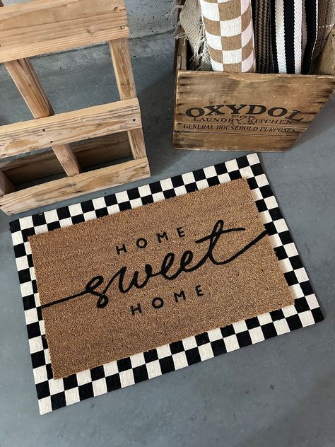 Elevate your doorstep with our "Home Sweet Home" doormat. Crafted for durability and style, this weather-resistant mat features charming lettering to warmly welcome guests. With a non-slip backing for safety, it's perfect for both indoor and outdoor use. Make a statement and add a touch of cozy flair to your home entrance today! House Decorating Ideas Entryway, Matte Black House Decor, Checkered Front Door Mat, Front Door Exterior Decor, Cozy Home Details, Small Home Farmhouse Decor, Layering Rugs Front Door Front Porch, Layered Front Porch Rugs Outdoor, Home Sweet Home Doormat