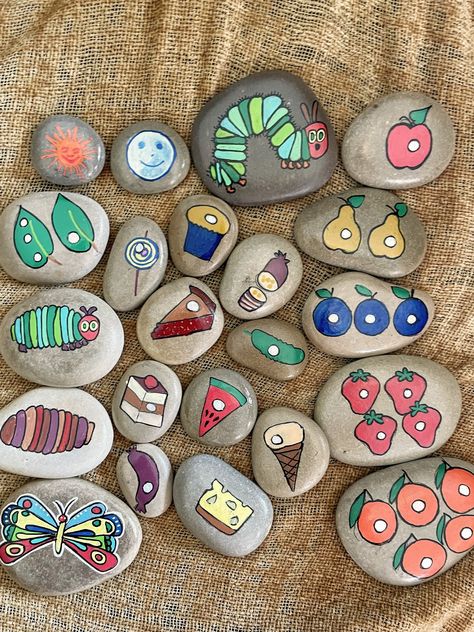 Use The Hungry Caterpillar story stones to building vocabulary and for general play. They can be used by parents and professionals in a variety of ways.  Children can play with the stones as the story is told, o, at a more advanced level  children can be asked to order the stones while you tell the story or while they tell the story themselves.  These are some of the ways to use these stones but I'm sure you can think of many more!  The stones also offer a smooth tactile experience for a more im Story Rocks Ideas Painted Stones, Story Rocks, The Hungry Caterpillar, Building Vocabulary, Fine Motor Activities For Kids, Christian Stories, Story Stones, Easter Story, Rock Painting Ideas Easy