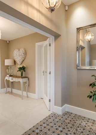 A hallway is great to greet your guests with fun and style. I love bold flooring, warm colours and a personal touch - here's one we made earlier 🎉 #interiordesign #hallwayenvy #colourtherapy House Paint Colours Internal, Light Paint Colours For Living Room, Coloured Hallway Ideas, Passage Colour Ideas, Entrance Hall Paint Colours, Stone Colour Hallway, Color For Hall Living Rooms, Beige Hallway Paint, Cashmere Hallway