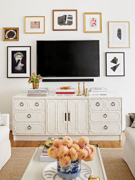 A wall-mounted TV masquerades as part of a gallery wall. Tv Over Dresser In Bedroom Mounted, Credenza Decor With Tv, How To Style Around A Mounted Tv, Dresser Styling With Tv Above, Mounted Tv Above Dresser, Dresser Decor Tv Above, Tv Above Dresser Bedroom Mounted, Tv Mounted Above Dresser, Bedroom Gallery Wall Above Dresser