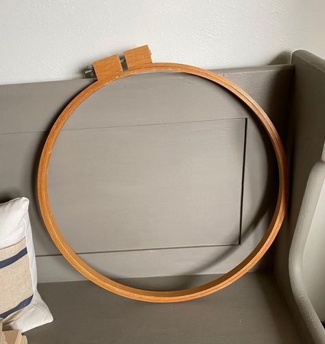 When I found a large wooden quilt hoop at Goodwill, I decided that it would make a great art frame. Here is the 19" quilt frame I purchased at Goodwill in a lighter wood tone stain. First, I wiped down the two hoops with a rag and hot soapy water. Then, I brushed Minwax Gel Stain in Walnut on the larger, outer hoop to darken it up. I left it to dry overnight. I pulled out my large DecoArt Mandala 18" x 18" Stencil and taped it on a square of burlap f… Mandalas, Minwax Gel Stain, Quilt Frame, Stenciled Wall Decor, Wooden Quilt, Large Scale Wall Art, Quilting Hoops, Organized Clutter, Anthropologie Candle