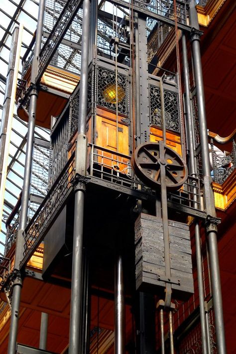 The Bradbury Building is an architectural landmark located at 304 South Broadway at West 3rd Street in downtown Los Angeles, California. Built in 1893, the five-story office building is best known for its extraordinary skylit atrium of access walkways, stairs and elevators, and their ornate ironwork. The building was commissioned by Los Angeles gold-mining millionaire Lewis L. Bradbury and constructed by draftsman George Wyman from the original design by Sumner Hunt. Bradbury Building, Building Photo, Elevator Design, Art Steampunk, Architecture Landmark, Photo Beautiful, Facade Architecture, Structure Design, Beautiful Architecture