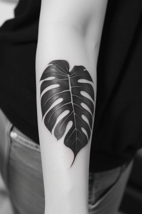 A captivating monstera leaf hand tattoo, featuring skillful shading, realistic lines, and a graceful design, exuding the charm of nature. This elegant design highlights the beauty of the monstera leaf, making it an ideal choice for those seeking a meaningful and artistic representation of their love for the natural world on their hand. Leaf Tattoo Monstera, Black Monstera Tattoo, Black Plant Tattoo, Big Leaf Tattoo, Black Leaf Tattoo, Black Leaves Tattoo, Leaf Hand Tattoo, Monstera Tattoos, Monstera Leaf Tattoo