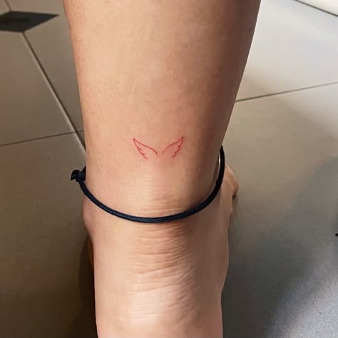 Minimalist red angel wing tattoo on your Achilles heel! Angel Wing On Ankle, Red Angel Wing Tattoo, Micro Ankle Tattoo, Red Angel Wings Tattoo, Red Minimal Tattoo, Red Wing Tattoo, Fine Line Angel Wings, Red Angel Tattoo, Achilles Heel Tattoo