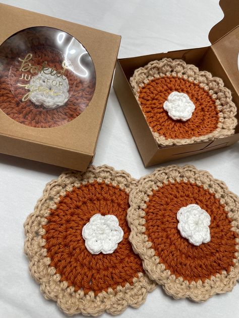 Hi, these cute coasters inspired by another artist here in Etsy, they're not exactly the same as I didn't follow the pattern but still cute none the less!! You get one for 7 and it's meant to be a gift, it says baked for you, and it's just so cute like a personalized pie. the set of 4 will come in one box, as a set.  The amount of 10 will not include a box.  If you want two have all individually wrapped in their own box please reach out and we can create a custom order for you  Thank you!! Crochet Baking Gifts, Pumpkin Pie Crochet Coaster, Crochet Fall Placemats Free Pattern, Fall Crocheting Ideas, Pumpkin Pie Coasters Crochet, Quirky Crochet Patterns Free, Crochet Pumpkin Pie Coaster, Crochet Apple Coaster, Crochet Gift Wrapping Ideas