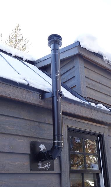 Here you can see the thimble installed. It allows the pipe to pass through the wall but keeps all combustibles far enough away to be safe. Hence the large hole in the wall. Diy Indoor Wood Burning Stove, Wood Stove Installation Wall, Wood Stove Chimney Ideas, Wood Stove Pipe Through Wall, Garage Wood Stove, Wood Stove Pipe, Vermont Castings Wood Stove, Outdoor Wood Stove, Corner Wood Stove