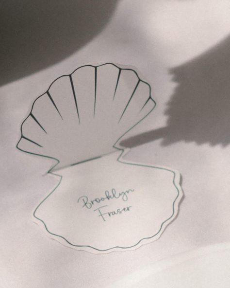 This elevated Shell Shaped Place Card is perfect for your next wedding, bridal shower, baby shower or event.  You can instantly download the editable template and begin placing your names. INSTANTLY EDIT WITH CANVA After your purchase, you will receive a link with a PDF file to your Shell Place Card Template within minutes of ordering. Open your email, click the link and upload your PDF file to Canva. You can edit the template immediately in your browser using Canva. We recommend duplicating each page and replacing the name content to ensure the size and shape stay consistent prior to printing. Upon the centre line, this is where you fold the place card to sit on the table like in the image above.  DOWNLOAD INCLUDES 15cm x 15cm Art board  Shell Design  Name text YOU CAN EDIT - Text - Font Seashell Place Cards Wedding, Dinner Name Place Cards, Place Cards Ideas, Name Cards For Wedding, Shell Place Cards, Coastal Chic Wedding, Unique Place Cards, Wedding Name Place Cards, Name Place Cards Wedding