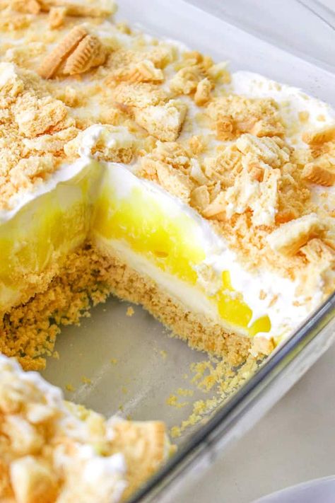 This Lemon Delight is a sweet, creamy no bake lemon dessert with layers of Golden Oreo, sweet cheese, lemon pudding, and whipped cream. Whether you call this recipe Lemon Delight or Lemon Lush, it's going to be a hit this summer! Lemon Cream Cheese Graham Cracker Dessert, Heavenly Lemon Oreo Dessert, Lemon Pudding Cool Whip Dessert, Lemon Dream Whip Cake, Instant Lemon Pudding Dessert, Lemon Oreo Cookie Dessert, Four Layer Delight Recipe, Lemon Cream Cheese Dessert Recipes, Lemon Delight Dessert