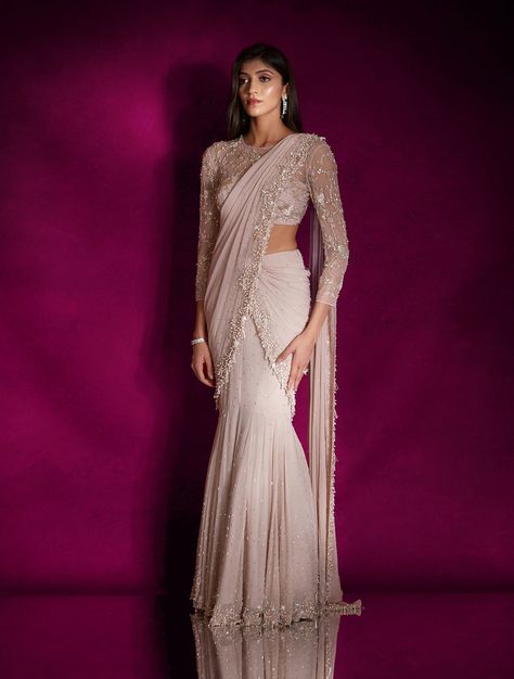 Dusty pink georgette fish style sari heavily hand embellished with pearls, silver glass beads, mixed materials & tassels, paired with a champagne and silver floral embellished sheer blouse featuring an open back.From Shloka Khialani's Winter Sun collection.DELIVERY TIMEPlease allow 6-8 weeks for your outfit to arrive.FABRIC DETAILSGeorgette, NetProfessional cleaning only. Mermaid Style Lengha, Saree Pattern Dress, Mermaid Lehenga Indian Fashion, Fish Cute Gown Indian, Mummy Cocktail, Western Sarees Fashion, Panache Sarees, Outfit For Sangeet Function, Mermaid Style Saree