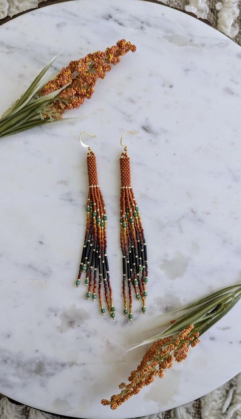 Change of Seasons 🍂 For those wild at heart, made with love.  Beautiful handmade orange tassel beaded earrings with Picasso turquoise accents and black bugle beads throughout. Made with high quality delica seed beads and fire polished beads. Gold plated stainless steel hooks. Métis Beading, Bugle Bead Earrings, Delica Beaded Earrings, Beaded Christmas Earrings, Seed Bead Tassel Earrings, Indigenous Beading, Miyuki Earrings, Bead Bottle, Diy Seed Bead Earrings