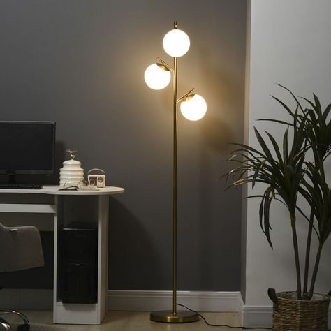 Introducing our 3-Light Multi-Head Floor Lamp, a sleek and modern lighting solution that adds charm and brightness to any room. This floor lamp features a slimline pole with three globe lampshades stemming off, creating a stylish and eye-catching design that complements various spaces, including the living room, office, and bedroom. With three bright light sources, this reading lamp provides ample illumination that easily fills the entire room. Whether you need focused lighting for reading or a well-lit space for other activities, this lamp delivers on brightness and functionality. Using the lamp is effortless with the on/off foot switch conveniently placed on the electrical cord. You can easily turn the lamp on or off, even when your hands are full. The lamp comes with a long 5.9 ft. powe Living Room Tree, Bedside Floor Lamp, Floor Lamps For Living Room, Modern Standing Lamps, Lamps For Living Room, Tree Floor Lamp, Lamps Bedroom, Gold Floor Lamp, Tall Lamps