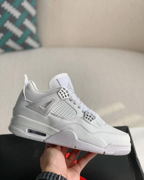 Channel timeless sneaker culture with the HolloVault Air 4 Retro. This homage to the legendary Air Jordan 4 "Pure Money" features a premium tumbled leather upper in pristine white, accented with metallic silver details for a touch of luxury. Breathable mesh panels and a visible Air unit ensure all-day comfort and support, while the iconic herringbone traction pattern delivers a confident stride. Premium Tumbled Leather: Luxurious feel and durable construction for long-lasting wear. Metallic Silv Men’s White Shoes, Jordan 4 Pure Money, Jordan 4 White, Jordan 4’s, Jordan Retro 4, Pretty Sneakers, Retro 4, Pretty Shoes Sneakers, Air Jordan 4 Retro