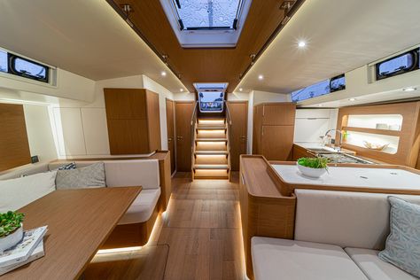 The objective in designing the interior was to create a warm, modern atmosphere with as much natural light and ventilation as possible. The Oceanis Yacht 54’s layouts reflect a desire to meet the needs of modern-day owners, through well-engineered, versatile cabin arrangements that provide unrivaled levels of comfort and capacious storage space. Pilothouse Sailboat, Yacht Decor Boat Interior, Walnut Interior, Boat Interior Design, Flat Interior Design, Sailboat Interior, Boat Interiors, Yacht Interior Design, Sailboats For Sale