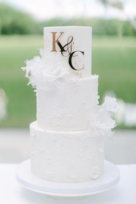 3-tiered white wedding cake Diy White Wedding Decorations, Off White Wedding Cake, 3 Tier Wedding Cake With Initials, White Wedding Cake With Gold Accent, Wedding Cake With Initial On Cake, Wedding 3 Tier Cake, 3 Tier Wedding Cake White And Gold, Wedding Cake Designs Elegant White, 3 Tier Wedding Cake Ideas Elegant