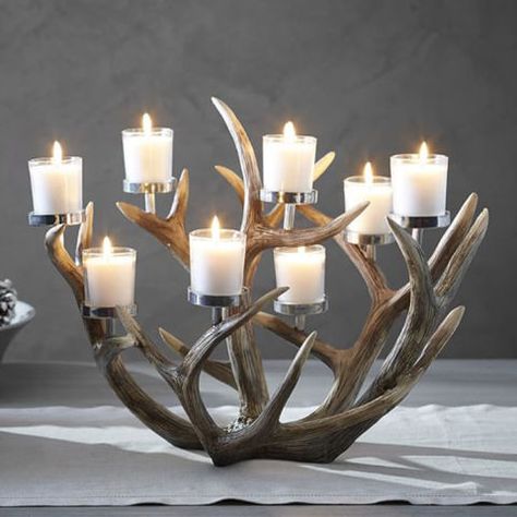 Whether you have a non-working fireplace or would rather not deal with the hassle of building a fire, you can still enjoy a warm, flickering light from your hearth anytime by sparking one of these fireplace candle holders. Decorating With Deer Mounts, Deer Antler Candle Holder, Antler Floor Lamp, Antler Centerpiece, Votive Centerpieces, Fireplace Candles, Antler Candle Holder, Fireplace Candle Holder, Antler Projects