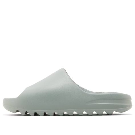 The adidas Yeezy Slide 'Salt' epitomizes minimalist design and comfort. This sandal features the brand’s signature aesthetic. Its allover grey color scheme exudes understated elegance. Constructed from lightweight injected EVA foam, the slide boasts an open-toe design for ventilation. The deep horizontal grooves on the outsole provide a grippy textured traction pattern. Salt Yeezy Slides Outfit, Grey Yeezy, Yeezy Slides Outfit, Yeezy Slides, Slides Outfit, Grey Color Scheme, Eva Foam, Grey Outfit, Adidas Yeezy