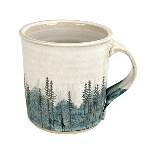 Artist: Red Bison Studio Approximately 4" tall x 4" wide This mug features a hazy blue mountain landscape behind several bunches of lodge pole pines. A bright large sun stands alone in the sky, and pearlescent glaze covers the inside and outside of the mug. Inspired by driving up a winding road into the Big Horn Mountains in Northern Wyoming. I hope this transports you to your favorite forested mountain spot. Food, dishwasher and oven safe, but it is actual gold on the mug so it is not microwava Mountain Mug Pottery, Mountain Mugs, Ceramic Mountain, Xmas Mugs, Mountain Mug, Mugs Diy, Line Artist, Mountain Tree, Mountain Pottery