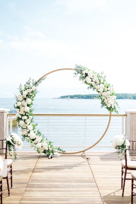 Circle arbor with white flowers for outdoor Beauport Hotel wedding on the water in Gloucester, MA. Photography by Sarah Surette. Wedding Arch Round Flowers, Wedding Arbour White Flowers, Circle Arbor Wedding Flowers, White Flower Wedding Decoration, Circle Arch Wedding Flowers, Circular Arbor Wedding, Circle Alter Wedding, Round Wedding Arbor, Circle Arbor Wedding