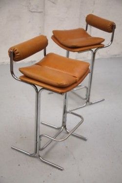 A Pair of Pieff Bar Stools A great pair of stools by Pieff, Worcestershire. Circa 1970. Brown leather seats and backs with chrome frames. The leather is quite stiff and firm, but still in good conditi Modern Leather Bar Stools, Mid Century Bar Stools Kitchen, Bar Stool And Dining Chair, Post Modern Bar Stools, Bar Stools Vintage, Mid Century Stool, 70s Bar Stools, Cool Bar Stools Modern, Apartment Bar Stools