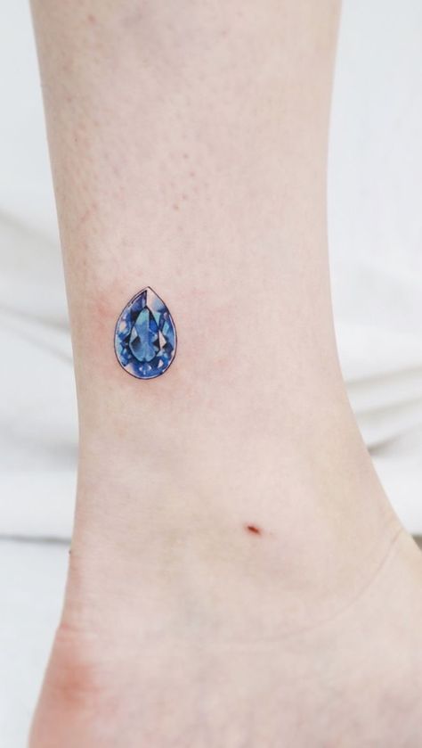 Blue Gem Tattoo, Blue Sapphire Tattoo, Sapphire Tattoo Ideas, Sapphire Tattoo, Small Diamond Tattoo, Small Black Tattoos, Jewelry Tattoo Designs, Stone Tattoo, Gem Tattoo