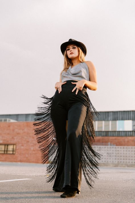 "Get your boots, get your hat and let's ride into the sunset! These bell bottom pants are a little bit country, a little bit rock and roll. They have extra long fringe all the way down the sides but they're matte black so you mostly catch it while in motion, such a dramatic effect! These trousers are also super easy to wear since they are very stretchy, you just pull them on, they have a high waist but you can fold the waistband down if you want.  Made to order Inseam: 32\" to 34\" Material: bla Western Attire For Women, Cowgirl Inspired Outfit, Style Black Trousers, Headshot Outfit, Goth Cowgirl, Fringe Bottom Jeans, Traje Cowgirl, Dancing Outfit, Estilo Cowgirl