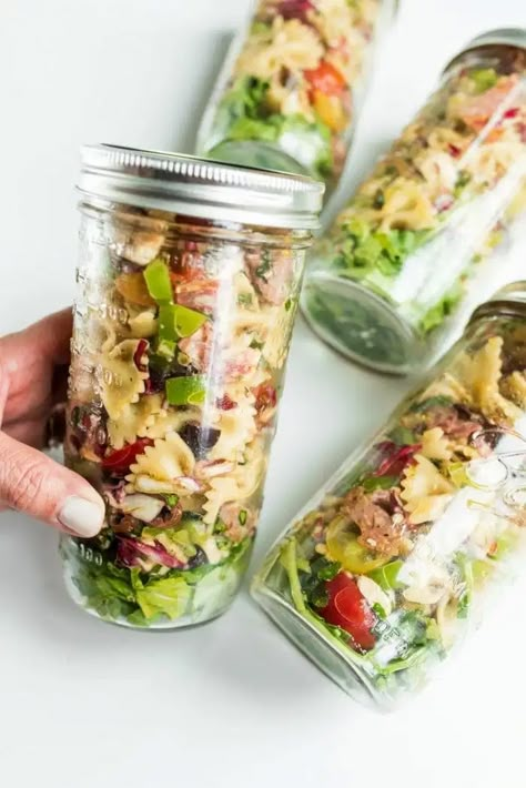 Bowtie Italian Pasta Salad in Jars consists of Farfalle pasta, salami, cheese, tomatoes, olives, Mozzarella cheese, and Italian dressing! #salladinajar #jarcuterie #reluctantentertainer Italian Salad In A Jar, Pasta Salad In A Jar Recipes, Pasta Salad In A Cup, Pasta Salad Mason Jar, Mason Jar Appetizers, Jar Pasta Salad, Pasta In A Jar, Pasta Salad In A Jar, Valentines Picnic