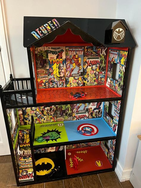 Black dolls house with superhero theme inside include Ironman, captain America, the hulk and Batman Toddler Boys Room Marvel, Marvel Toy Storage, Avenger Doll House, Diy Superhero Bedroom, Superhero House Diy, Marvel Playroom Ideas, Superhero Playroom Ideas, Avengers Doll House, Superhero Dolls House