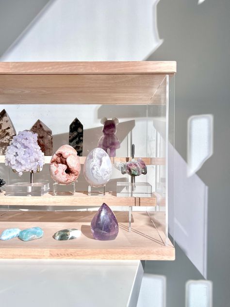 "Not sure how to organize your crystals and minerals? Tired of dusting your crystals and minerals? Need more space on your shelf or desk? Need your crystal display to be more organized? These crystal display cases were specifically designed and created by The Stone Queen Co for storing & displaying all of your precious crystals and minerals. There are three neutral colors to choose from - wood, white and black. Featuring a sleek, simple and elegant design, this is the perfect accessory for your crystal display.    --- Made from acrylic and wood materials. --- The front panel slides L to R and can be completely removed for easy access to the shelves. --- There are 2 inner shelves that run from left to right and sit flush with the walls. --- The top shelf sits flush with the back wall (aka n Crystal Organization, Crystal Display Shelf, Crystal Storage, Crystal Room Decor, Crystal Stand, Be More Organized, Crystal Room, Crystal Shelves, Displaying Crystals