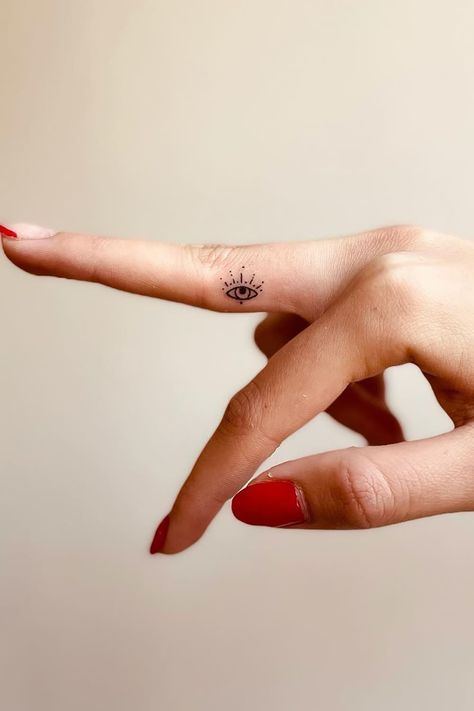 Small Eyes Tattoo, Evil Eye Finger Tattoo Simple, Evil Eye Tattoo On Wrist, Henna Designs Evil Eye, Third Eye Finger Tattoo, Lucky Eye Tattoo, Delicate Evil Eye Tattoo, All Knowing Eye Tattoo, Greek Eye Tattoo Minimalist