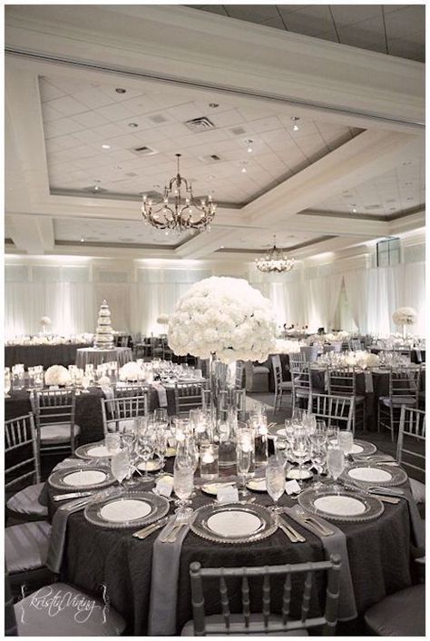 White centerpieces and charcoal gray and silver linens for a deluxe look. Photo: kristinviningphotoblog. Silver Chiavari Chairs, Silver Wedding Decorations, White Weddings Reception, 25th Wedding Anniversary, Black And White Decor, Wedding Decor Elegant, Gray Weddings, Nc Wedding, Resort Wedding