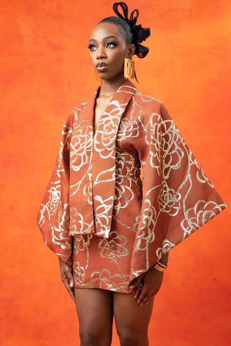 Introducing an updated version of our best selling kimono fitted dress. it features a kimono styled top half with a shawl collar and mini pencil skirt bottom. made in our custom kintsu floral brocade fabric in copper.  designed and produced with love in lagos, nigeria  -lower center back zip -bust circ = 34 inches -waist circ =  26 inches -hip circ = 38 inches -dress length = 35 inches above measurements are based on a 5 ft 7 model and wears an afrikrea size small dress.  item runs true to size Kimono Style Tops, Kimono Outfit, Dress Item, Mini Pencil Skirt, Fitted Mini Dress, Lagos Nigeria, Brocade Fabric, Kimono Dress, Small Dress