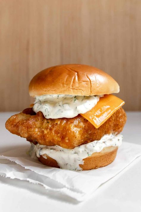 Inspired by the original Filet-O-Fish, our Fried Cod Fish Sandwich is crispy, tender, and tangy in every bite. With a large filet of crispy fried cod, this fish sandwich is topped with homemade tartar, a half slice of American cheese, and a steamed bun. It’s just like the classic McDonald's version but only better, in our opinion. Cod And Chips, Cod Sandwich Recipes, Fried Fish Sandwich Recipes, Fried Cod Sandwich, Fried Cod Fish Sandwich Recipes, Best Fish Sandwich, Crispy Cod Sandwich, Cod Fish Sandwich, Fried Cod Fish Recipes