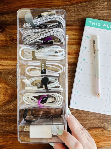 Are your charging cables and cords a tangled mess? Steal these easy ideas for organizing your cord clutter. Extra Cord Storage, Phone Cord Storage, Computer Cable Organization, Organize Electronic Cords, Charger Organizer Diy, Chord Organisation, Charging Cord Storage, How To Organize Chargers Cords, Organizing Electronics Cords