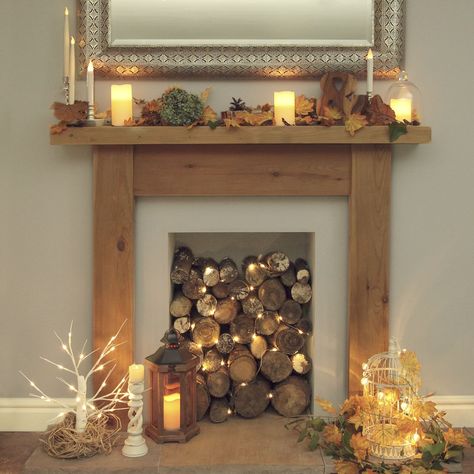 Wood Logs In Fireplace, Fireplace Filled With Logs, Decorative Logs In Fireplace, Old Fireplace Decor Ideas, Fireplace With Logs Inside, Fireplace Logs With Lights, Fireplace With Candles Ideas, Logs In Fireplace Decorative, Log Fireplace Ideas