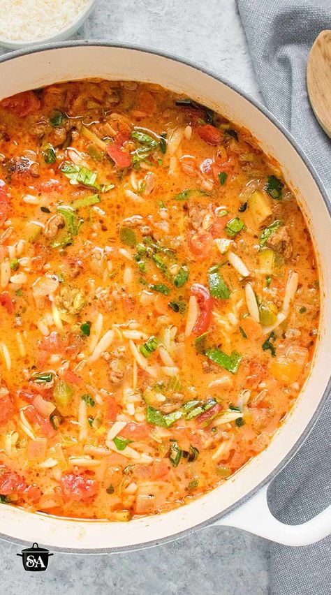 An overhead view of Italian Sausage Orzo Soup in a large white Dutch oven. Italian Sausage Orzo Soup, Soup Orzo, Sausage Orzo Soup, Italian Sausage Orzo, Sausage And Orzo, Sausage Orzo, Orzo Soup Recipes, Clean Eating Soup, Italian Sausage Recipes