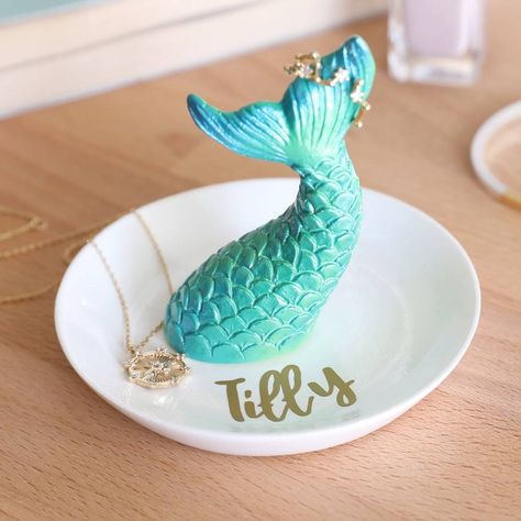 A magical mermaid tail trinket dish with name, from Lisa Angel Home. A wonderful spot to store your small jewellery pieces or trinkets, this dish features an iridescent green mermaid tail set onto a white ceramic base. Finished with a gold vinyl sticker name. Simply hang your items on the tail or place on the base. Character limit: up to 8 characters.  resin Jewelry Storage Diy, Stackers Jewellery, Key Bowl, Jewellery Dish, Gold Mermaid, Dish Storage, Mermaid Ring, Jewelry Organizer Storage, Mermaid Jewelry