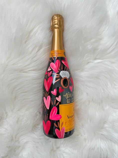 Valentines Aesthetic Decor, Hen Do House Decorations, Engagement Bottle Decoration, Engaged Champagne Bottle, Painted Champagne Bottle Valentines, Champagne Bottle Painting Engagement, Valentines Bottle Ideas, Pink Painted Champagne Bottle, Painted Veuve Bottle Engagement