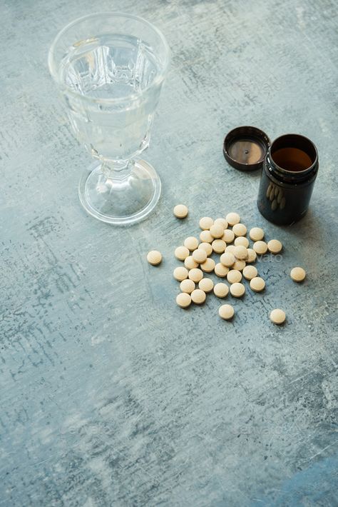 yellow round tablets pills vitamins, plastic bottle and glass cup by apagafonova. yellow round tablets or pills vitamins on blue stone concrete table with black plastic bottle and glass drinking cup,... #Sponsored #plastic, #bottle, #glass, #vitamins Pill Bottle Aesthetic, Pill Bottles Aesthetic, Pill Aesthetics, Jar Aesthetic, Sideshow Bob, Book Edits, Elizabeth Turner, Pill Bottle, Anti Aging Vitamins