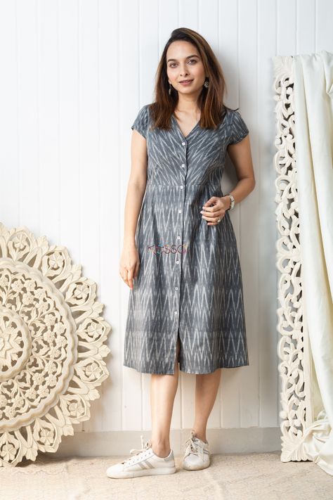 Cut in a distinct mid length A-line silhouette, the ikat grey mid-length dress is carefully handwoven with a dainty ikat pattern in grey and white tones. A great choice for daily-wear, this soft cotton outfit is embellished with front buttons, side pleats and V-neck. The dress comes with two side pockets. Ikat One Piece Dress, Front Button Frock Design, Cotton Daily Wear Dresses, Daily Wear Kurtas Cotton, Cotton A Line Frocks For Women, Cotton Ikat Dress, Aline Cotton Dress, Simple Daily Wear Kurti Design, Cotton Frock Ideas For Women