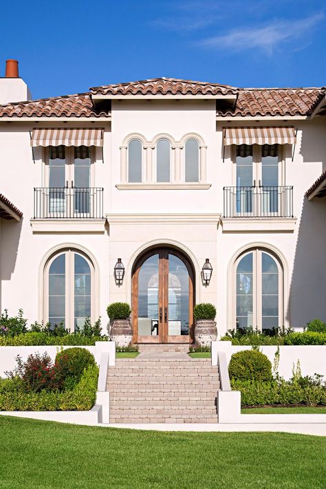 These Mediterranean-inspired homes showcase timeless style with global appeal. With ties to historic European architecture, Mediterranean-style homes remind of sun-soaked, seaside locales. #curbappeal #mediterraneanstylehomes #mediterraneanhouseexterior #mediterraneanhousedesigns #bhg Mediterranean Exterior Homes, Mediterranean Homes Exterior, Mediterranean Exterior, Home Designs Exterior, California Architecture, Mediterranean Revival, Tuscan Landscaping, Mediterranean Style Home, Mediterranean Architecture