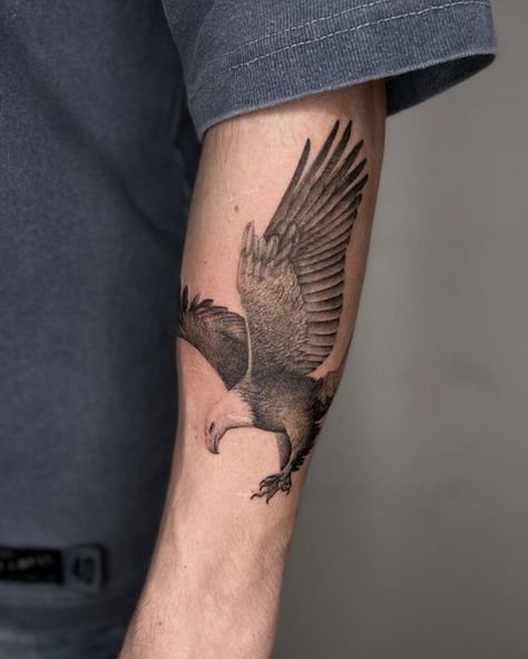 Eagle in Flight1 Detailed black and grey eagle tattoo on forearm, soaring with wings outstretched. Realistic design, impressive arm ink. | Sky Rye Design Eagle Diving Tattoo, Eagle Tattoo Men Arm Sleeve, Eagle Tattoo Forearm Men, Eagle Forearm Tattoo For Men, Mens Eagle Tattoo, Women Eagle Tattoo, Eagle Flying Tattoo, Bald Eagle Tattoo For Women, Eagle Tattoo For Women Feminine