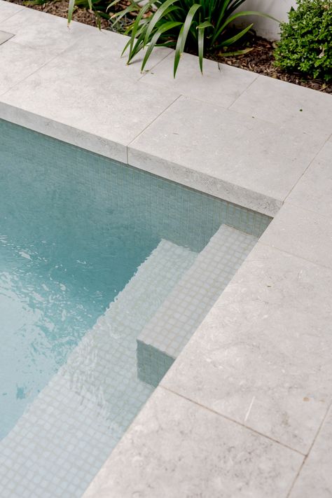 Pools With Stone Walls, Paving Around Pool Ideas, Pool Area Flooring, Concrete Pool Pavers, Pool Limestone Pavers, Outdoor Pool Tiles, Pool Edge Tile, Tiled Pool Area, Tiled Pool Steps