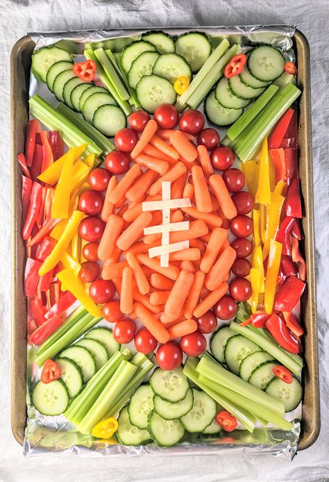 It's easy to make this adorable football veggie tray for your next watch party! Made with fresh veggies in the shape of a football. Veggie Tray Football Party, Football Vegetable Tray, Tailgate Veggie Tray, Football Party Drink Station, Football Party Foods For Kids, Football Fruit Tray, Football Birthday Party Snacks, 1st Down Football Birthday Party Food, Football Fruit Tray Ideas