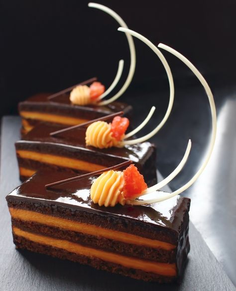 Orange Opera cake with citrus ganache and white chocolate - the Fall's way of making Opera cakes 😊🍊🍫 #orange #operacake #chocolatelove #homemade #dessert #recipe #printables ------------ . ⠀⠀⠀⠀⠀⠀⠀⠀⠀⠀⠀⠀⠀⠀⠀⠀⠀⠀⠀⠀⠀⁠ ᴛʜᴀɴᴋ ʏᴏᴜ ꜰᴏʀ ᴍᴀᴋɪɴɢ ᴏᴜʀ ᴡᴏʀᴋ ᴘᴏꜱꜱɪʙʟᴇ!⠀⠀ . ⁣⁠⠀⠀⠀ ⠀⁠ ➠ Become studio's Patron and get discounts and special offers 🏷️: https://www.patreon.com/marijacrow Cake Plating Ideas Desserts, Chocolate Orange Cake Design, Chocolate Opera Cake, Opera Cake Plating, Opera Cake Decoration, Opera Pastry, Chocolate Plated Desserts, Brownie Sheet Cake, Pastel Opera