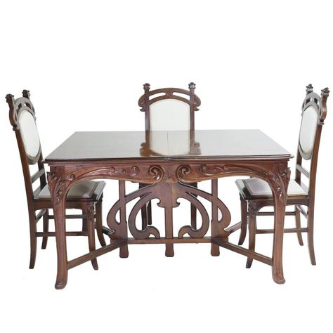 An exceptional Art Nouveau dining suite in walnut comprising of an extension table and six dining chairs that are original to the suite. Table features very well-articulated open and high-relief carvings of whiplash curves, a popular motif during the Art Nouveau period, and offers two original leaves that rest on drawer supports. Suite is from the region of Nord-Pas-de-Calais in France, from the city of Lille or possibly from across the border in Brussels, Belgium. #DiningTable #DiningChairs Clearance Patio Furniture, Modern Dining Room Chairs, Art Nouveau Furniture, French Art Nouveau, Antique Dining Tables, Patio Chair Cushions, Dining Room Chair, Dining Room Chairs Modern, Extension Table