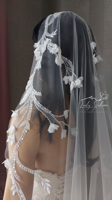 "Elegant flowers pearl wedding veil with beads and sequins. In her the bride will look mysterious and romantic. There is a comb at the top of the veil to secure it on the head. This veil is available in a variety of lengths. I can make custom veil for you with length and width that you specify from the style you like. If you have any questions please send me a message, I will be happy to discuss details. Width 60 \" (150cm) 36\"Fingertip length (90cm) 48\" Knee length (120 cm) 60\" Waltz length (150 cm) 72\" Floor length (180 cm) 85\" Chapel length (220 cm) 95\" Chapel length (240 cm) 108\" Cathedral length (270 cm) 120\" Royal length (300 cm) 140\" Royal length (350 cm) 160\" Royal length (400 cm) * Available color: Light ivory (off white) Two tier veil: www.etsy.com/listing/1588274298/3d Gold Vail Wedding Veils, Head Veil Wedding, Dreamy Wedding Veil, Irish Lace Wedding Veil, Veils Bridal Medium Length, Wedding Veil Cathedral Length, Royal Length Veil, Boho Wedding Veils, White Floral Veil